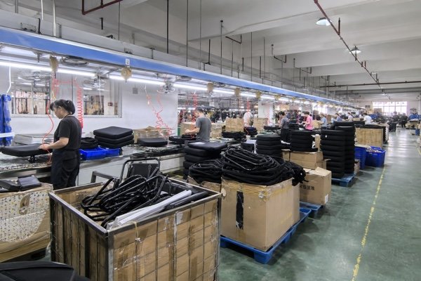 Office chair factory assembly line showing monthly production capacity