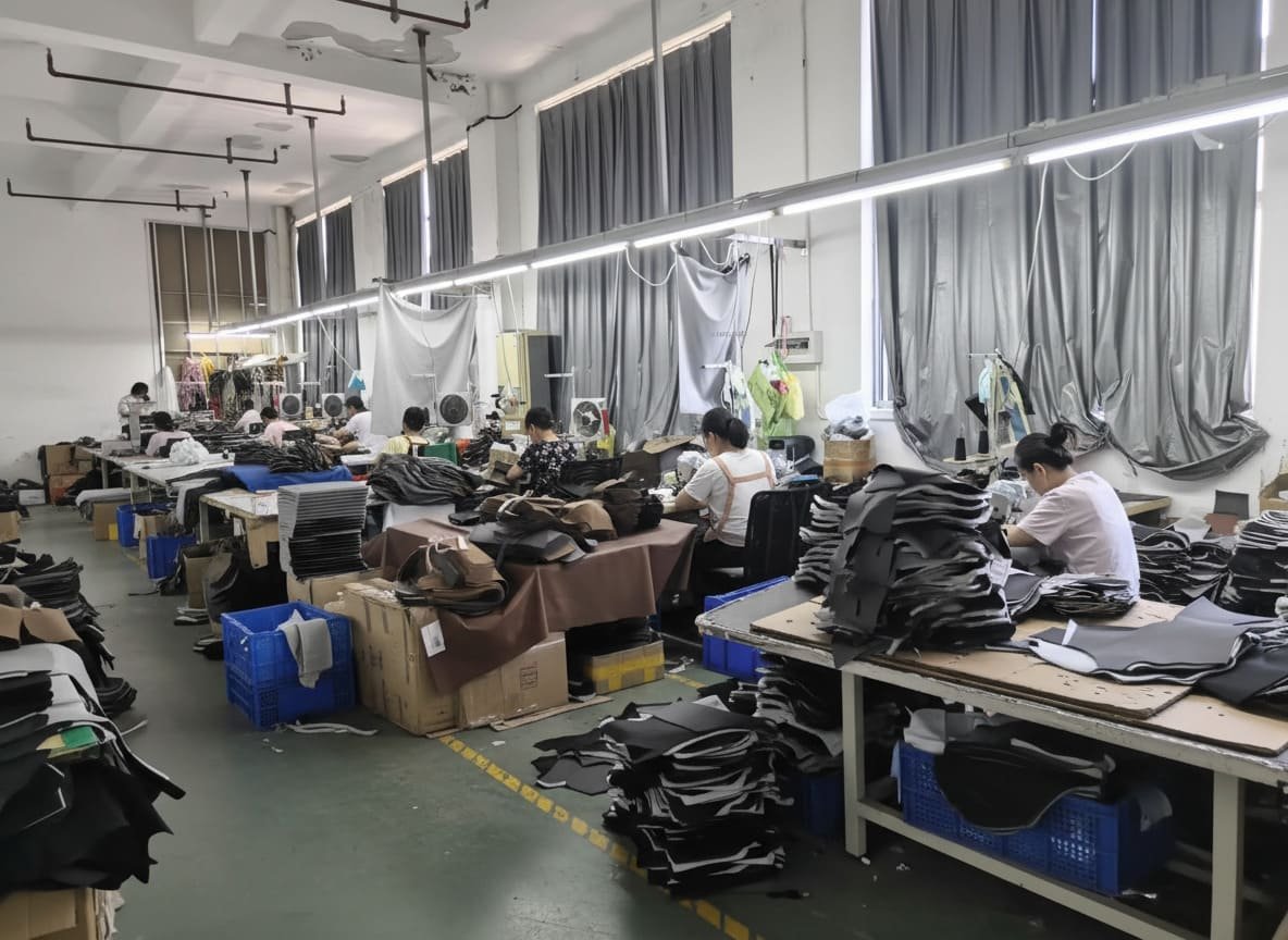 An assembly line of office chairs in a large factory